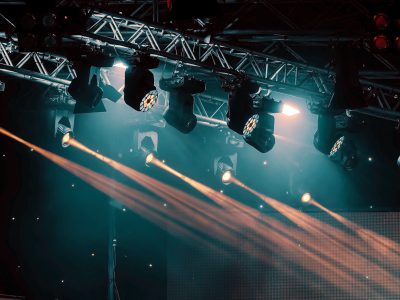 luminous rays from concert lighting against a dark background, musical instrument concept